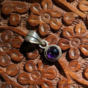 Sterling silver pendant with amethyst color stone